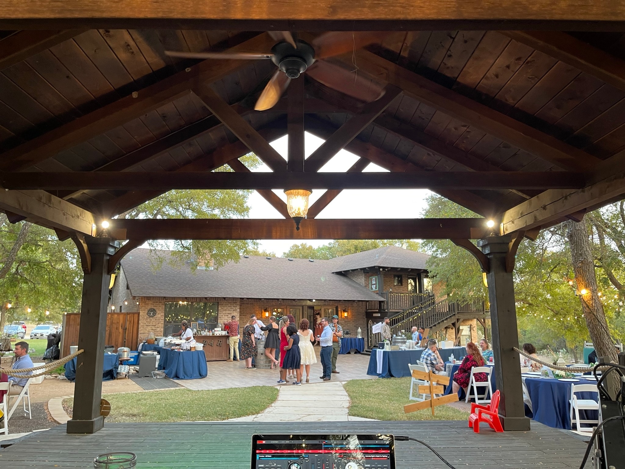 Outdoor wedding reception under wooden pavilion